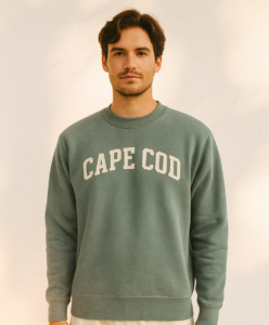 Young man wearing a gray sweatshirt with the text "Cape Cod" on it