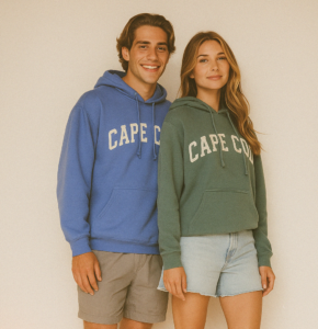 young man standing and smiling wearing a periwinkel hoodie sweatshirt and young woman wearing a green hoodie sweatshirt