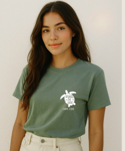 young woman wearing a short sleeve tee shirt with an illustration of a turtle and the text Respect the Locals Cape Cod on it